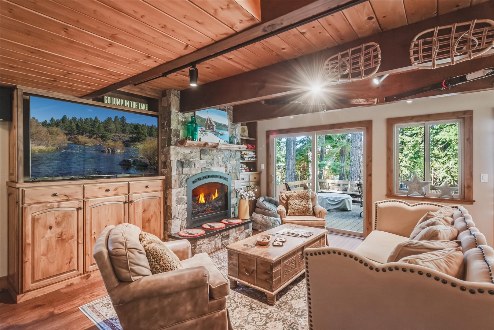 Curl up by the stone fireplace in this inviting living room, where rustic wood beams and cozy leather seating create your perfect mountain retreat.