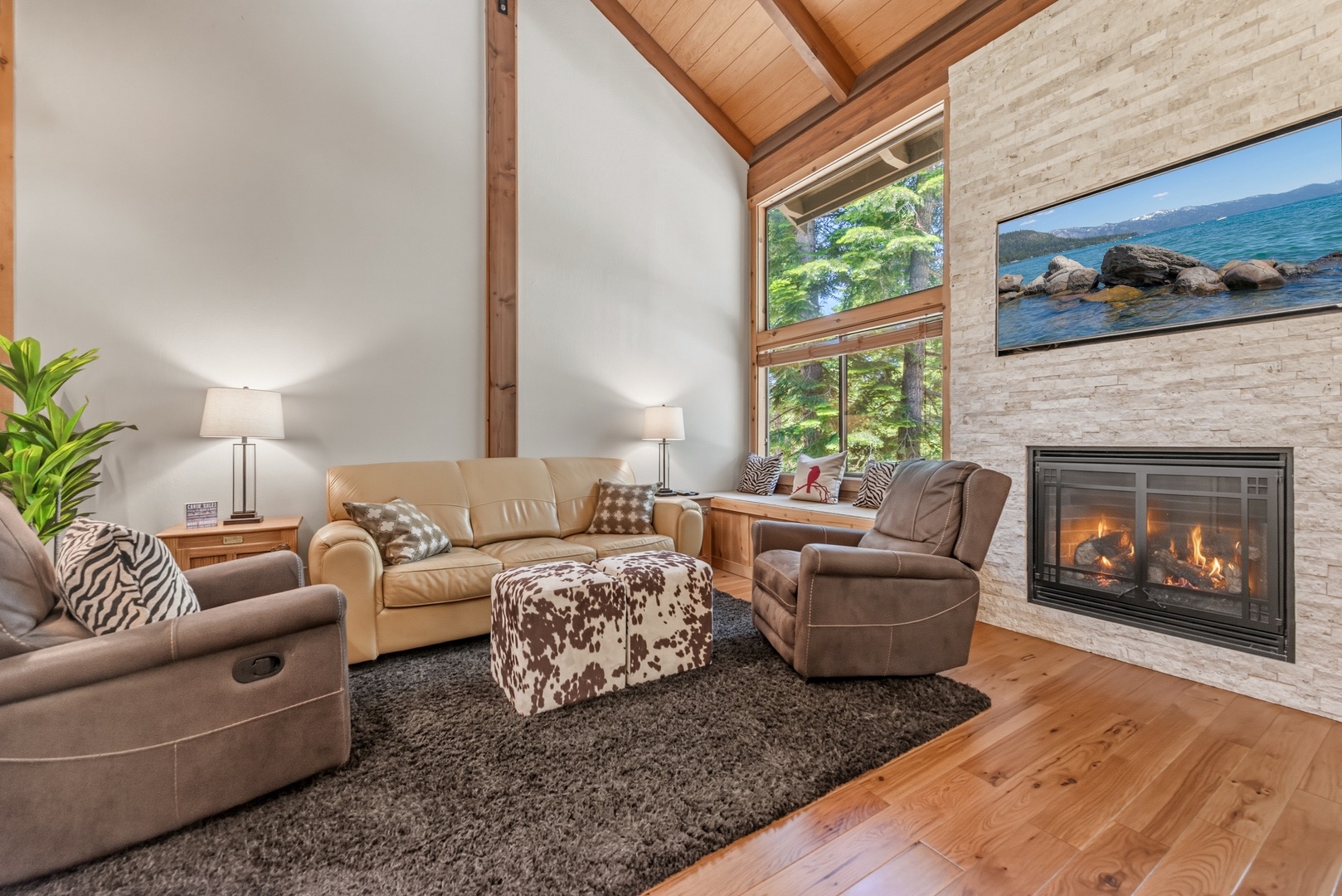 Settle into your cozy living room with soaring vaulted ceilings, lakefront views, and a warm fireplace perfect for mountain evenings.
