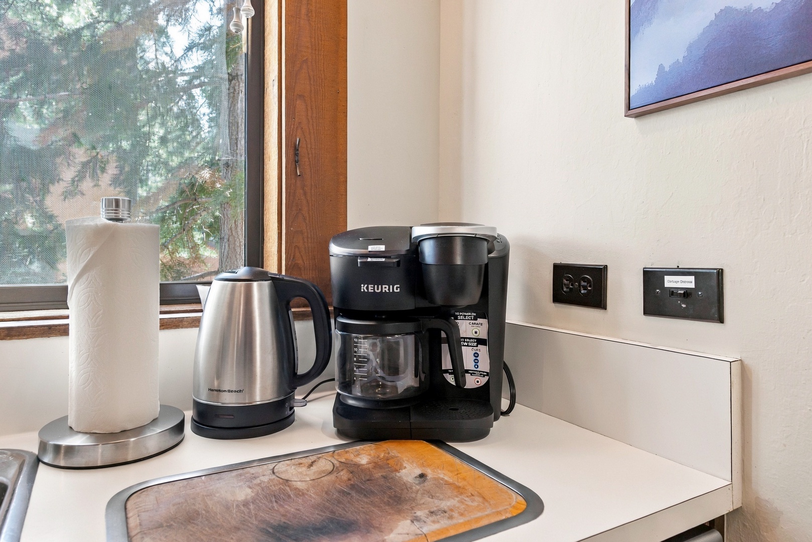 Brew your morning cup with ease using the Keurig and kettle, conveniently placed by the window to let natural light brighten your start to the day.