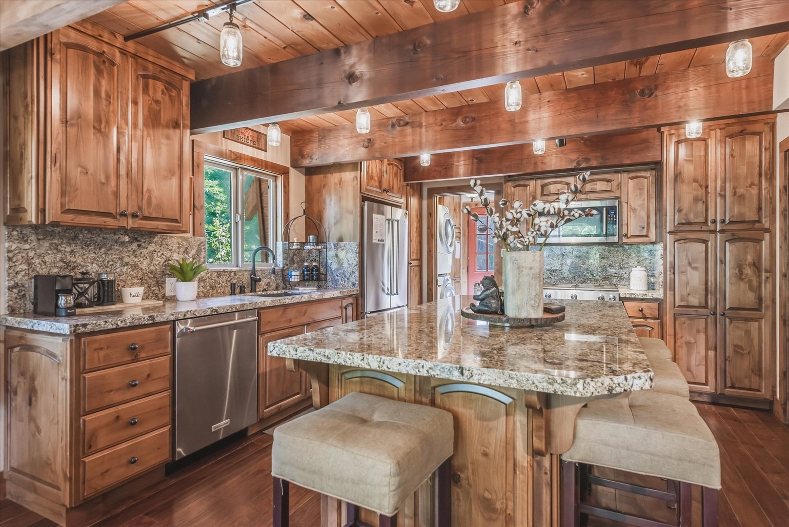 Cook up your favorite meals in this spacious gourmet kitchen, where rich wood cabinetry and gleaming granite countertops create a warm, welcoming space for gathering and creating memories.