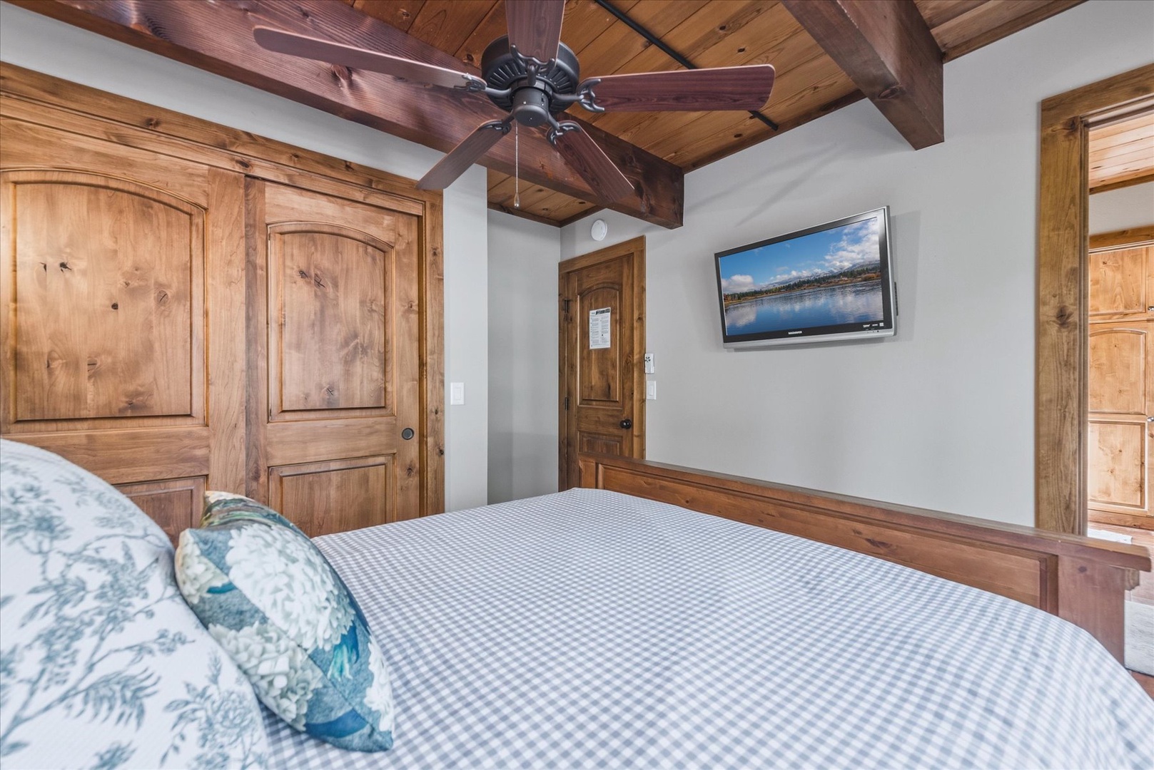 Your rustic retreat features a queen bed, warm timber accents, and a ceiling fan to keep you comfortable during your stay.