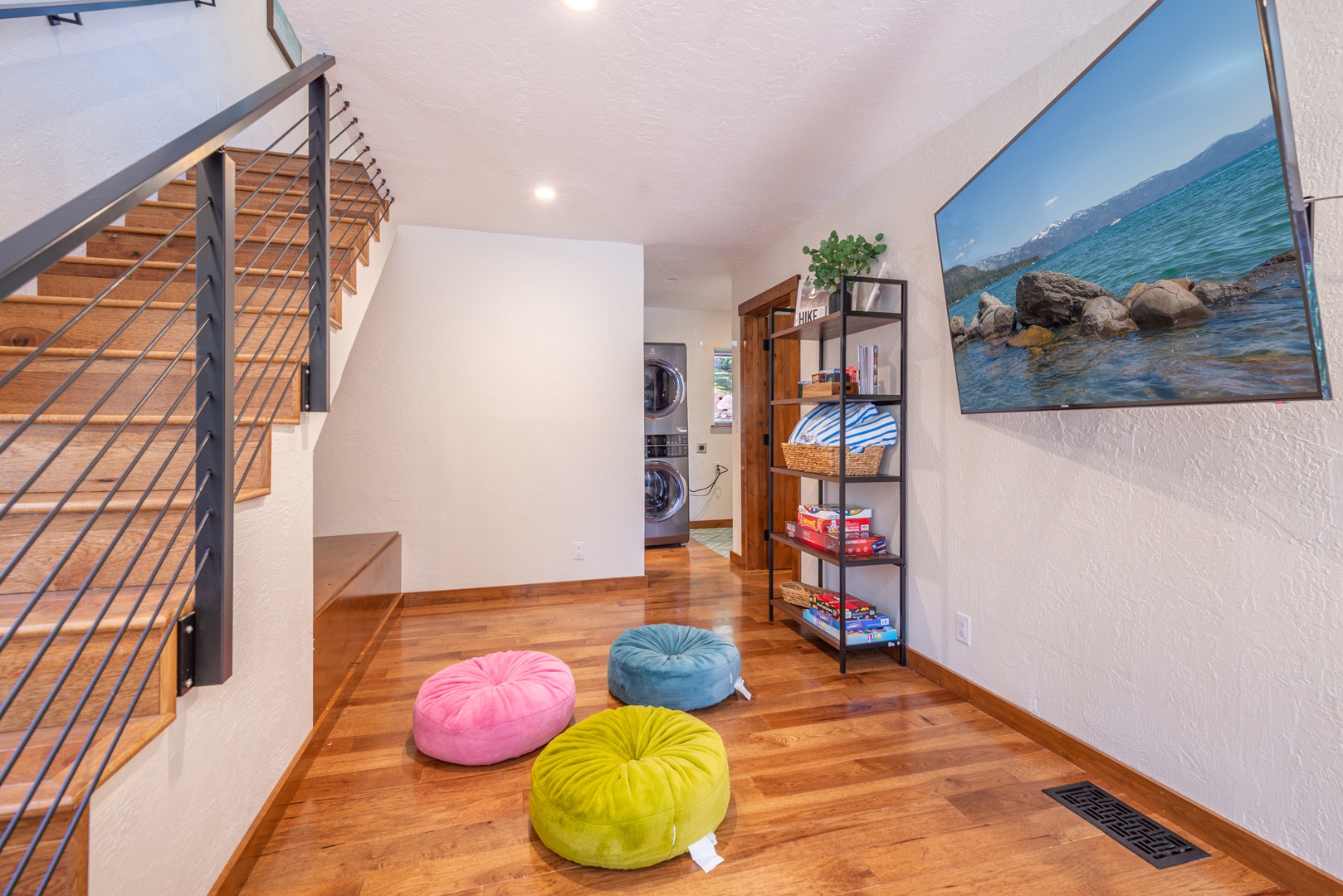 Settle into your cozy common area with colorful floor cushions for lounging, convenient laundry access, and stylish modern touches throughout.