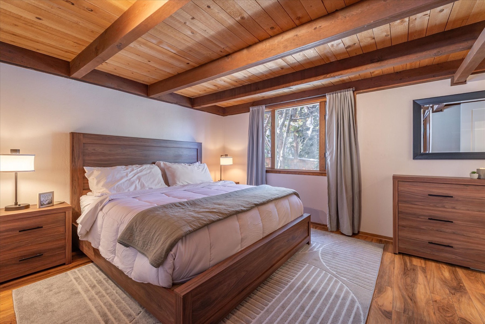 You'll drift peacefully to sleep beneath these stunning exposed wood beams, surrounded by warm alpine charm and modern comfort.