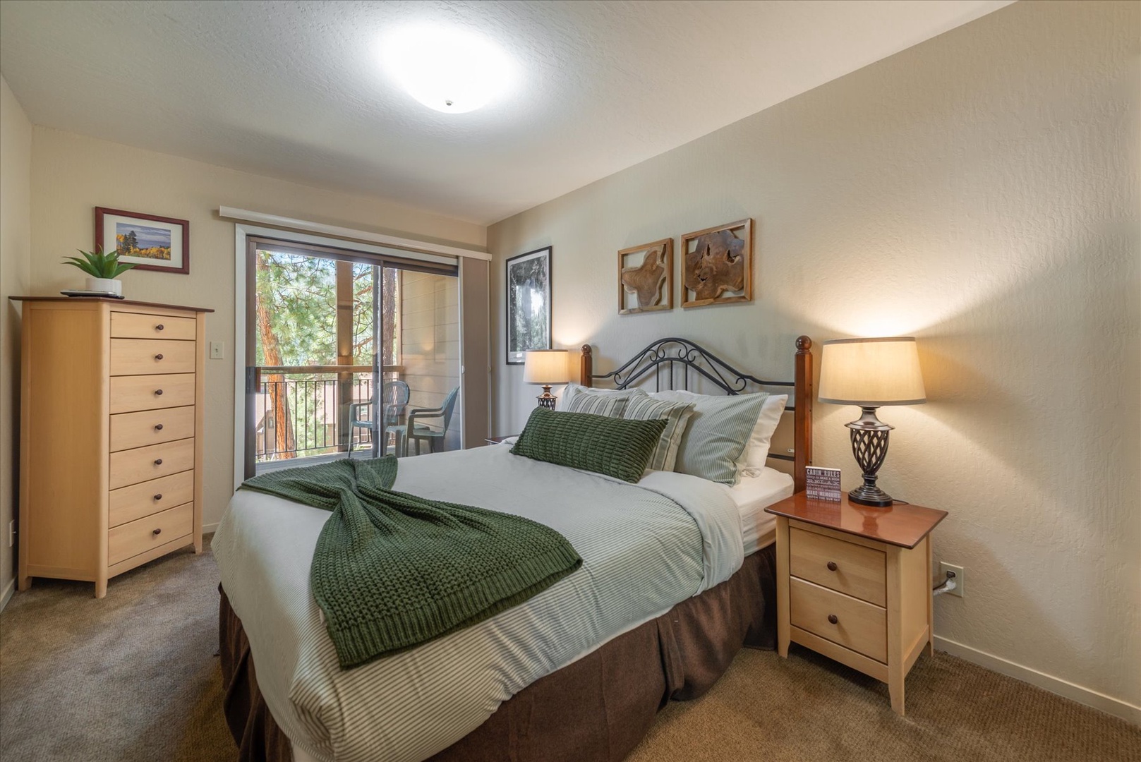 Sink into crisp linens and plush pillows in your peaceful bedroom retreat. Natural light pours through the balcony doors while elegant touches create a serene mountain escape.