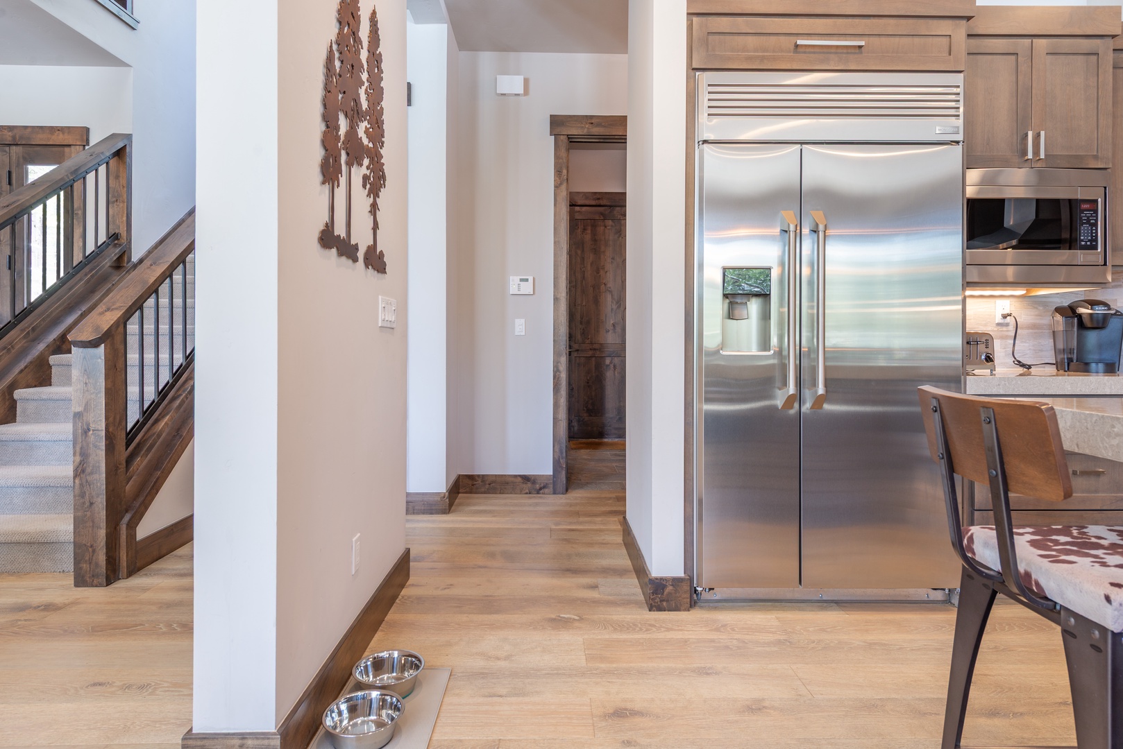 Your spacious kitchen features premium stainless steel appliances and warm wood finishes, creating the perfect space for memorable meal preparations.