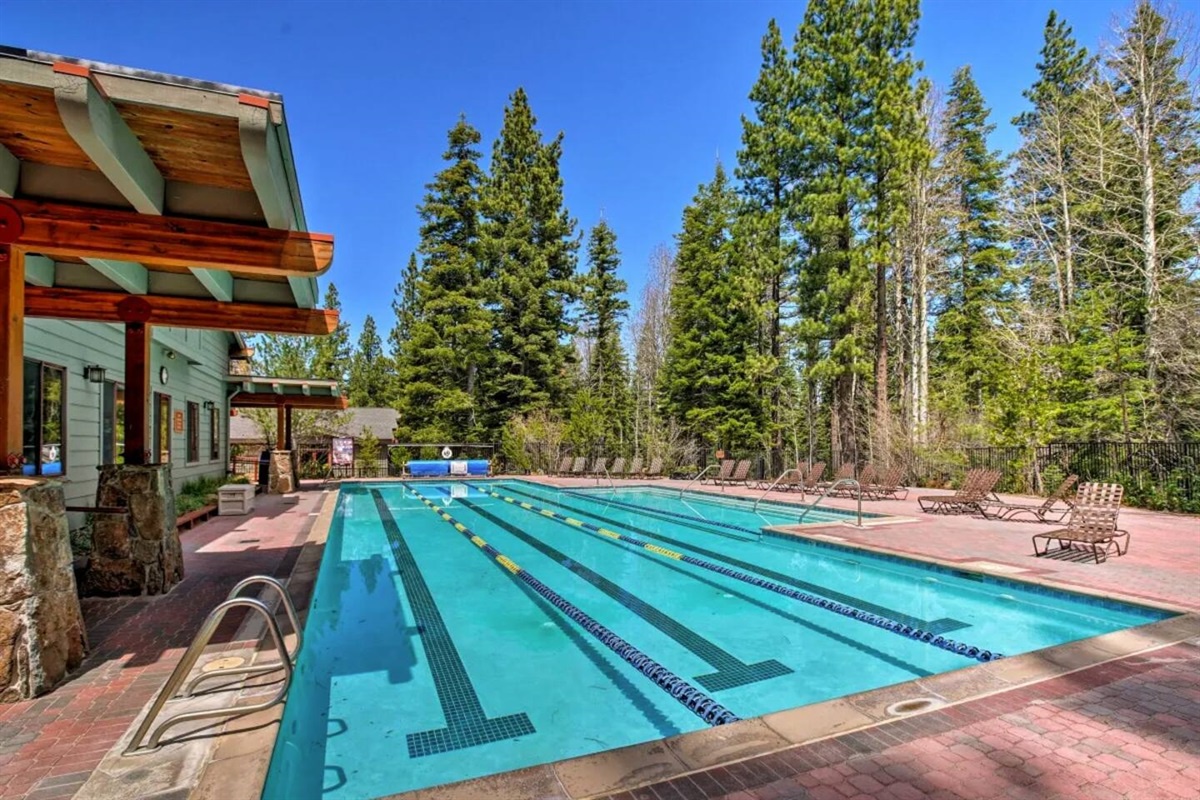 The NPOA rec center features a pristine lap pool set among towering pines, offering a peaceful spot to swim under clear mountain skies.