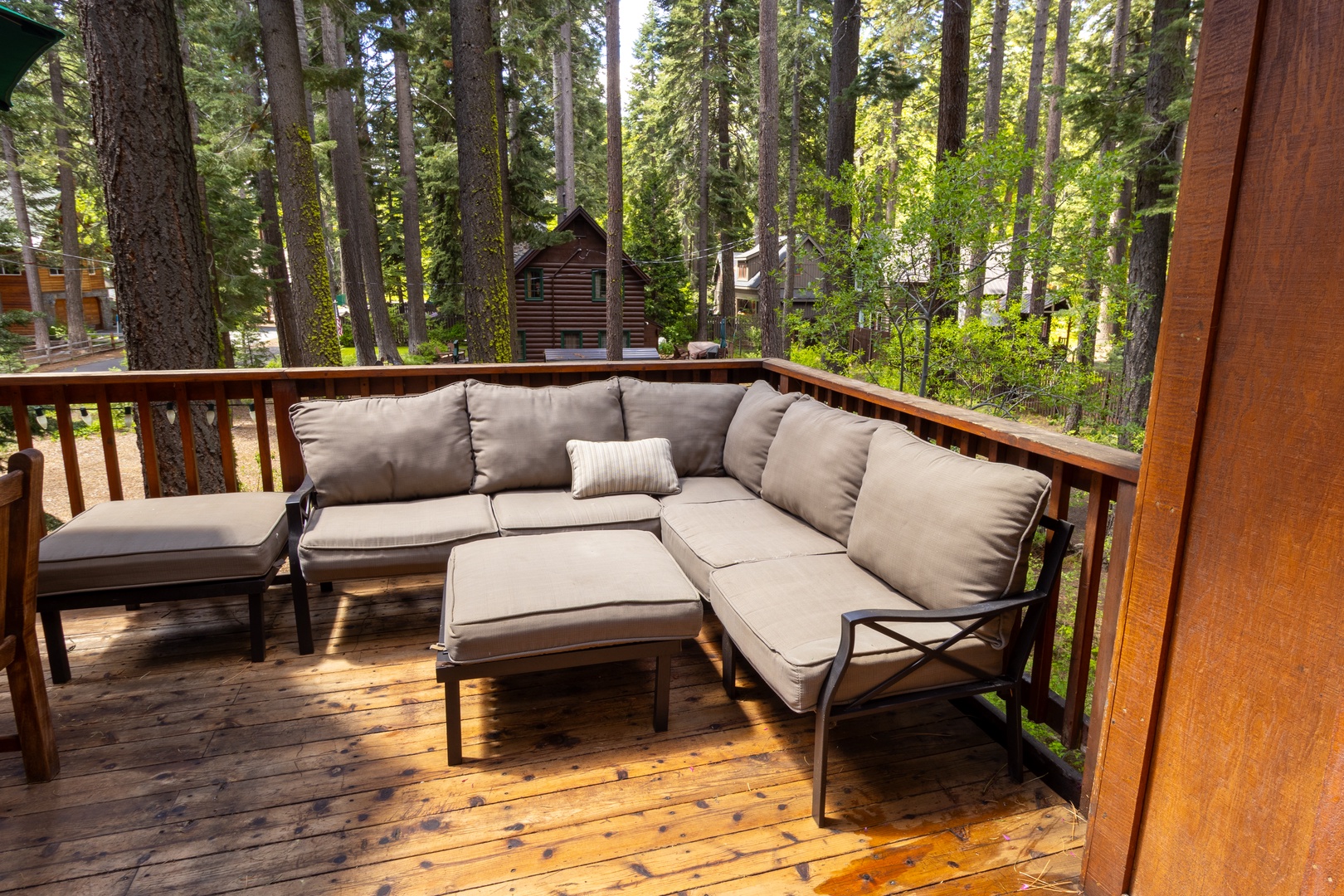 Sink into plush seating on your private deck, surrounded by towering pines. This peaceful forest retreat offers the perfect spot to sip morning coffee or unwind after a day of adventure.