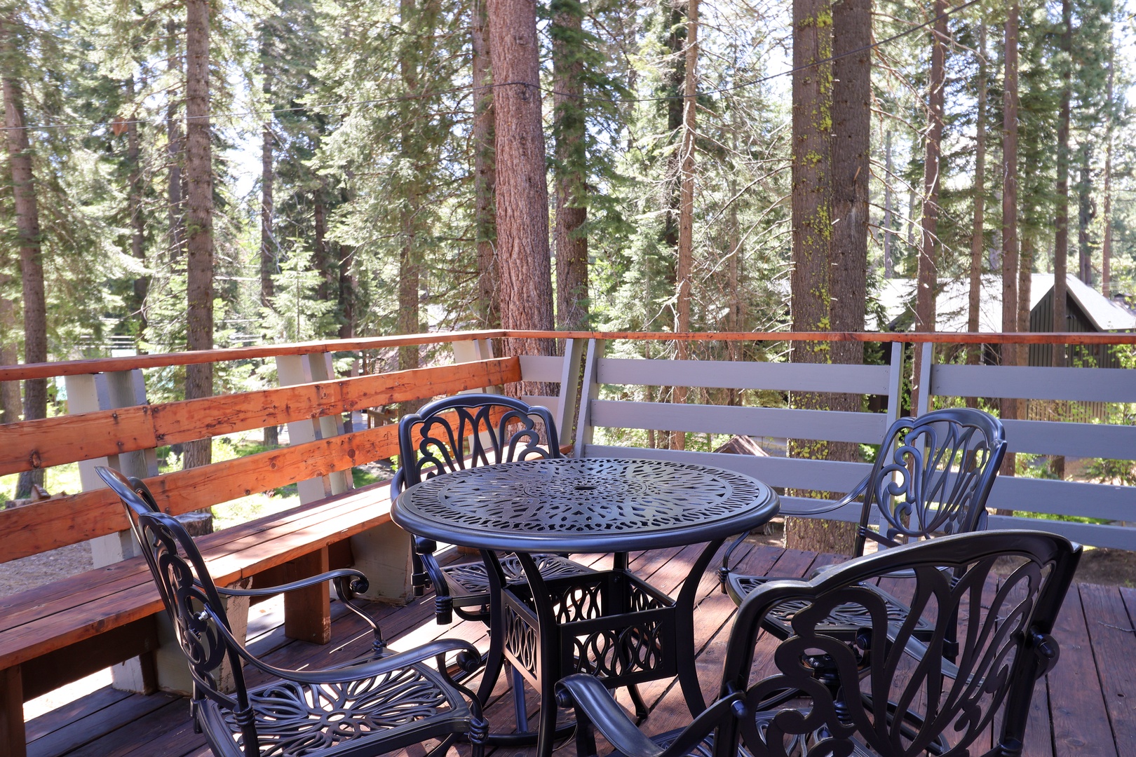 Step onto your private deck and settle into the outdoor seating surrounded by towering pines. This peaceful spot invites you to sip your morning coffee or unwind with evening conversation.