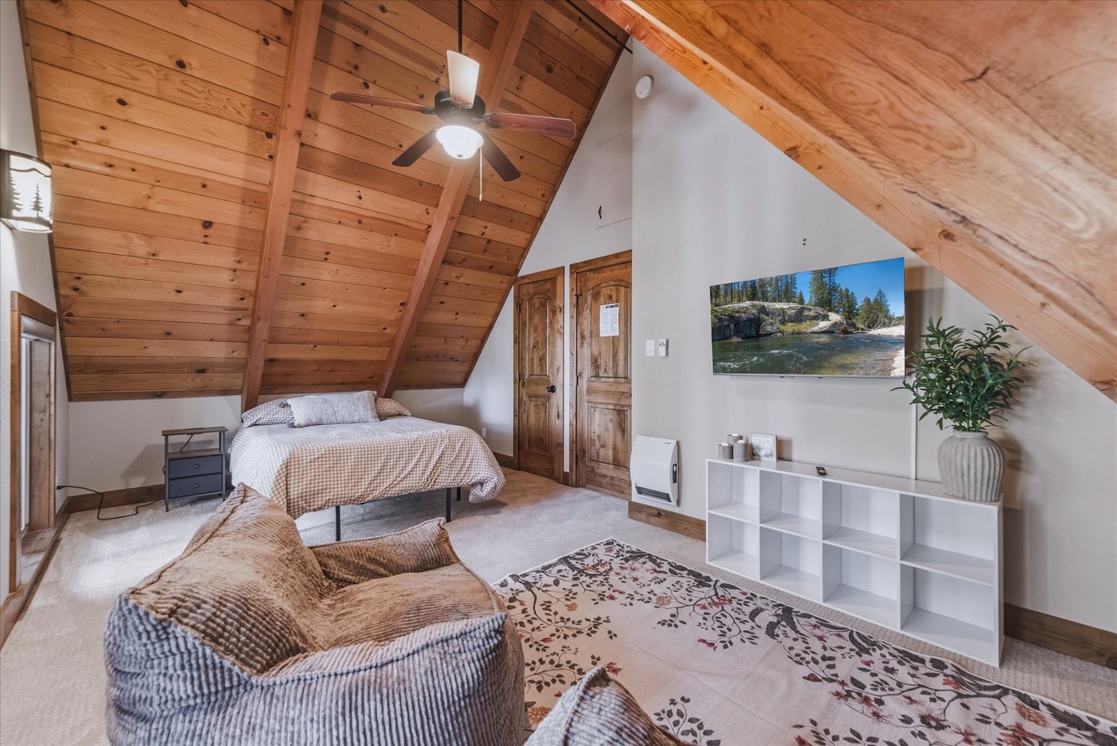 Unwind in your spacious upstairs bedroom, featuring a private lounge area.