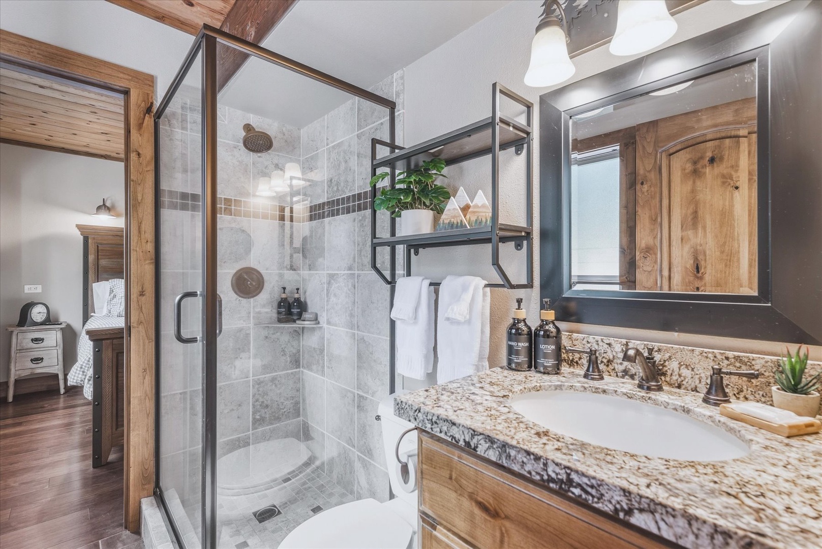 Step into your beautiful downstairs bathroom with rustic wood touches that blend luxury with mountain charm.