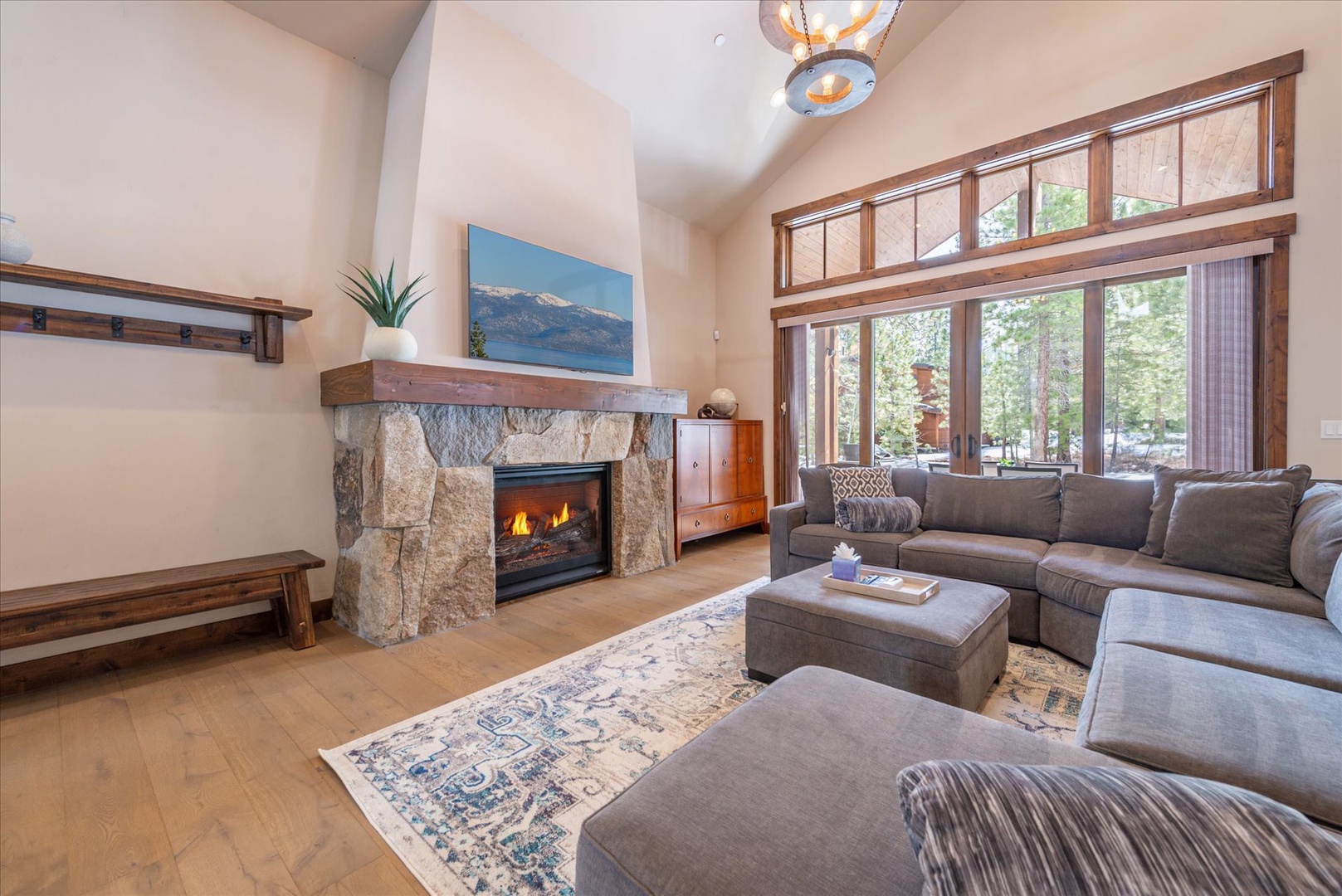 Sink into plush sofas by your crackling stone fireplace while forest views frame your mountain retreat.