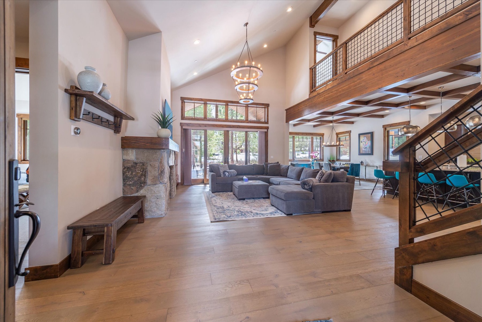 Step into your stunning mountain retreat where soaring ceilings and warm wood create the perfect gathering space for unforgettable moments.