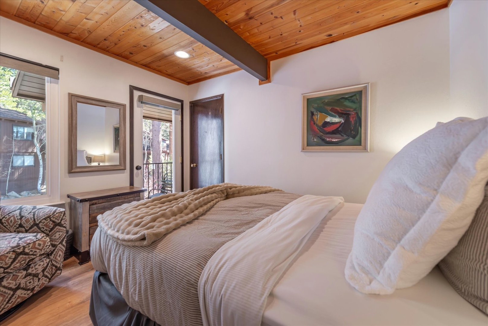 Rest peacefully under the beautiful exposed wood ceiling beams, with the door opening to your private balcony for fresh mountain air.