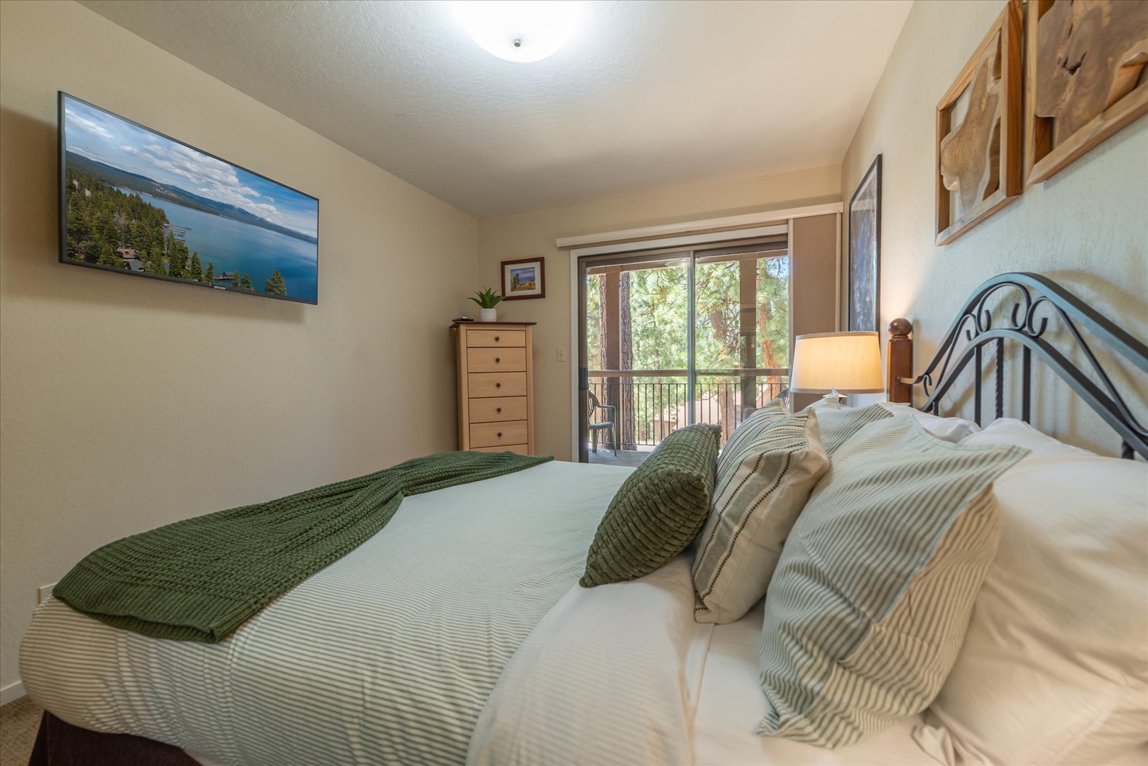 Drift off in this inviting bedroom where forest views greet you each morning through your private balcony doors. Soft linens and peaceful tones create your perfect mountain retreat.
