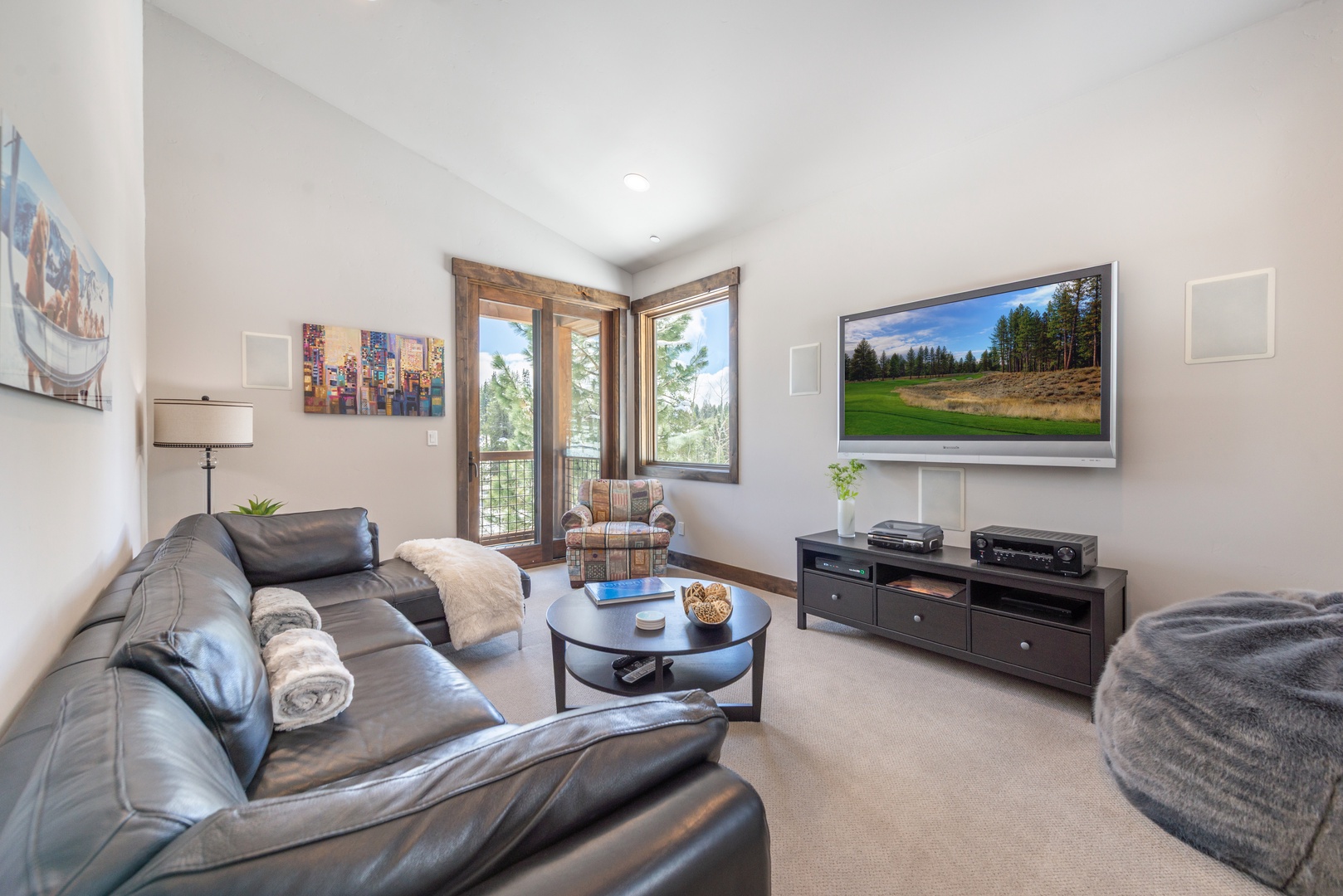 Sink into plush leather seating while enjoying your favorite shows on the large flat-screen TV in this cozy living room.