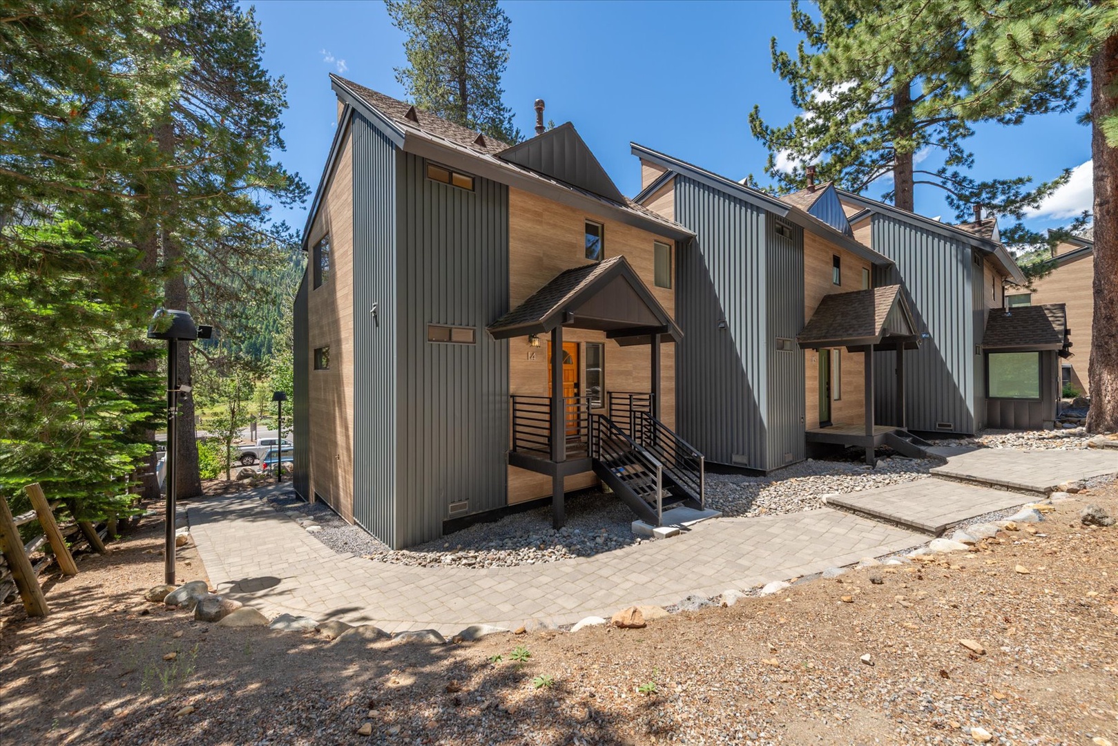 Modern mountain retreat with stunning architectural design, nestled among towering pines and surrounded by natural beauty, offering you a peaceful escape in a serene alpine setting.