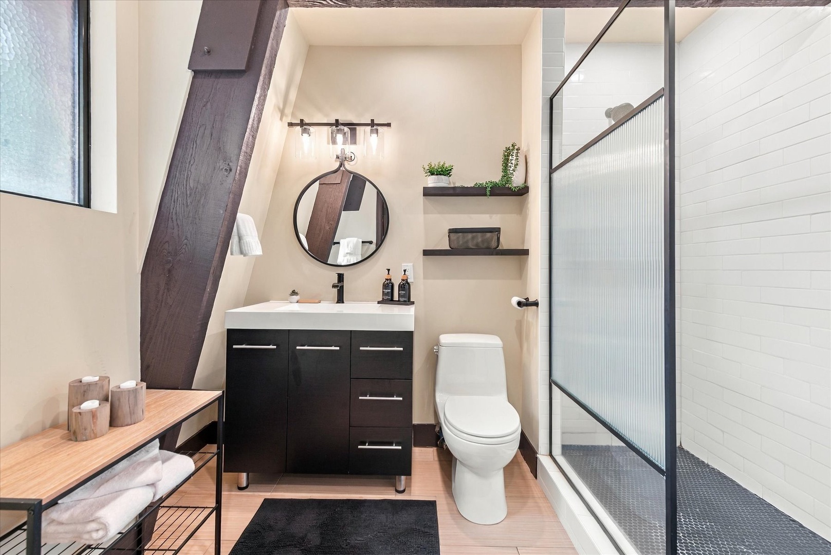 Refresh in your modern bathroom featuring a sleek glass-enclosed shower, stylish vanity, and thoughtful touches like spa-worthy amenities—designed for your comfort.