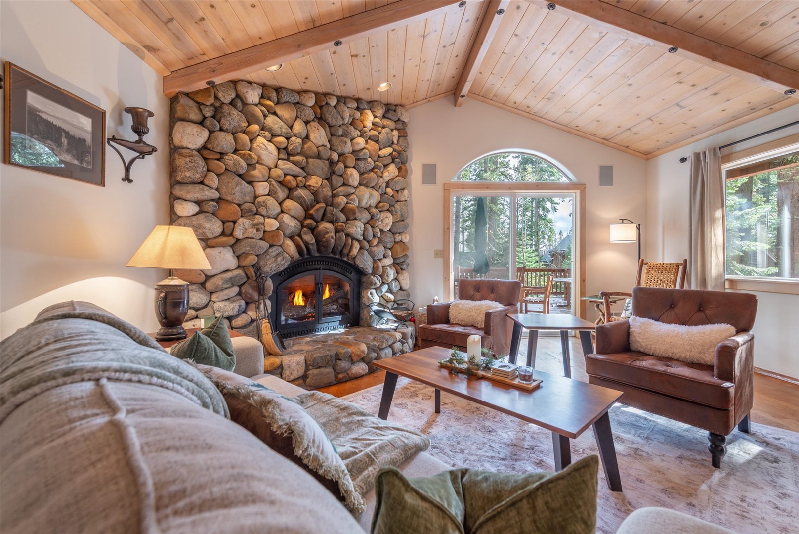 Curl up in this cozy living room, where vaulted wood ceilings and forest views create the perfect mountain retreat for unwinding after your adventures.