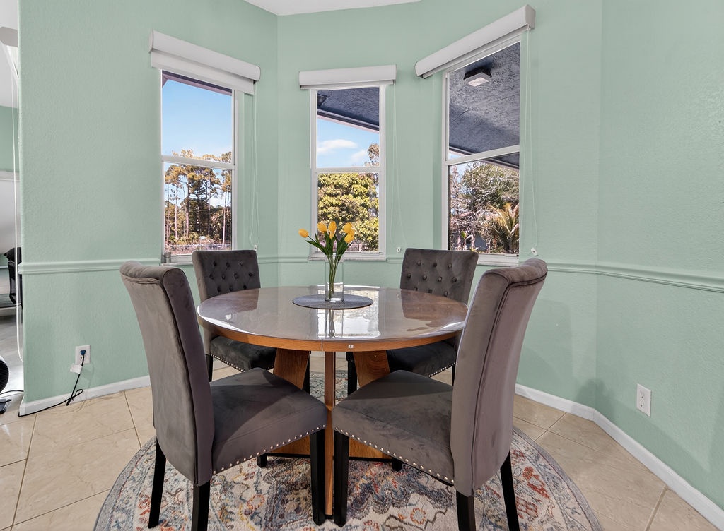 Gather around your elegant dining table with leafy garden views through every window—perfect for morning coffee or sunset dinners.