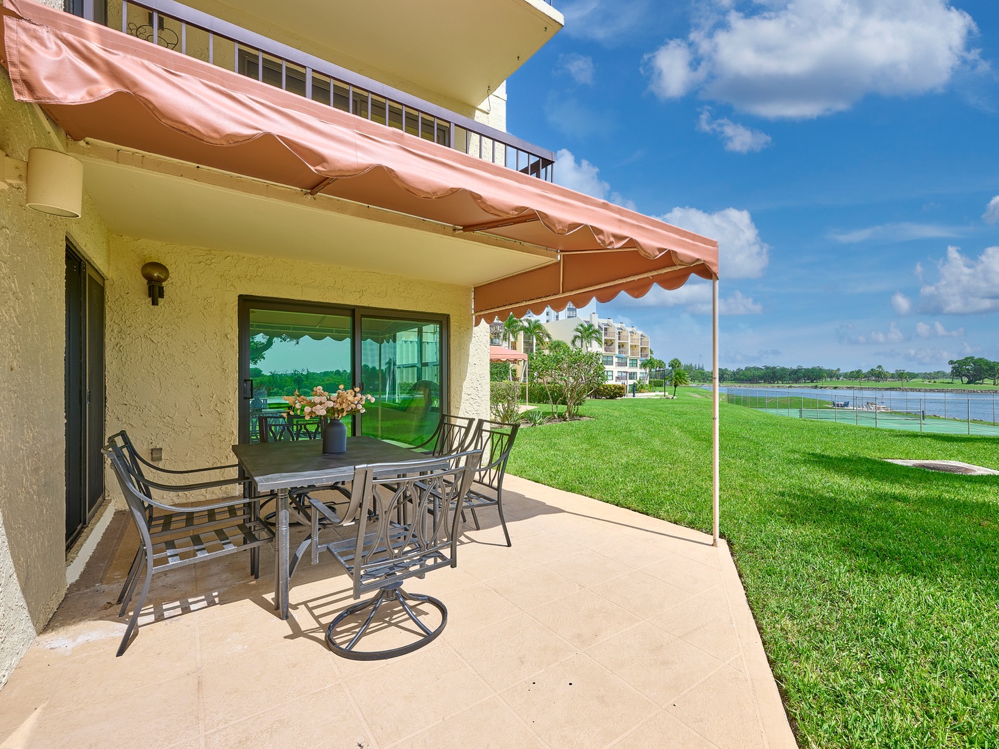 Your private patio opens to lush green lawns and peaceful lake views—perfect for morning coffee or sunset dinners outdoors.