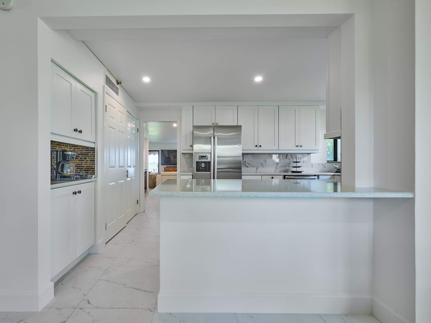 Your bright, modern kitchen awaits with sleek marble countertops, stainless steel appliances, and all the space you need to whip up vacation meals or morning coffee in style.