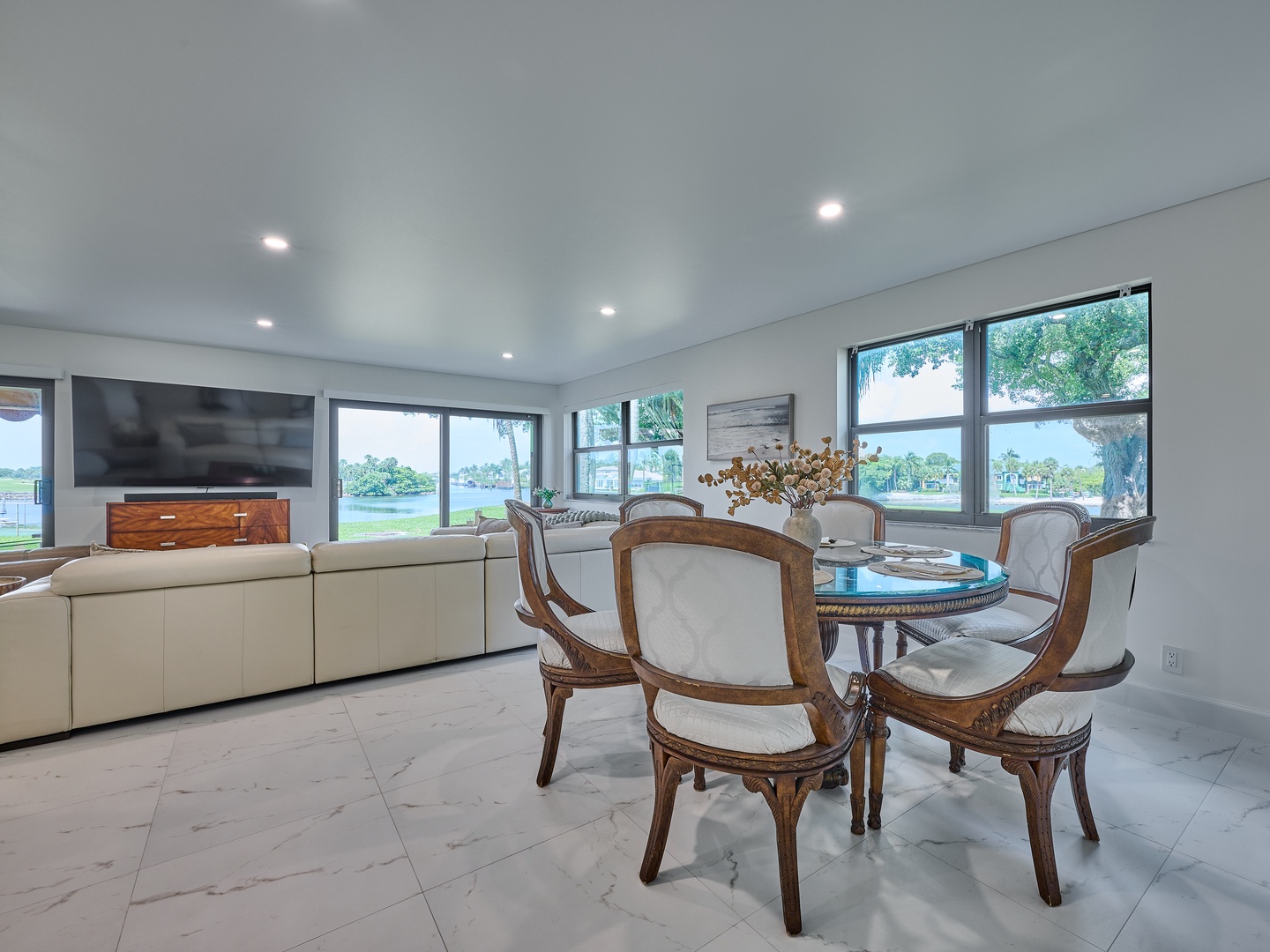Gather around for meals or morning coffee with sweeping water views framing your dining experience. Natural light fills the open, elegant space where your vacation moments unfold.