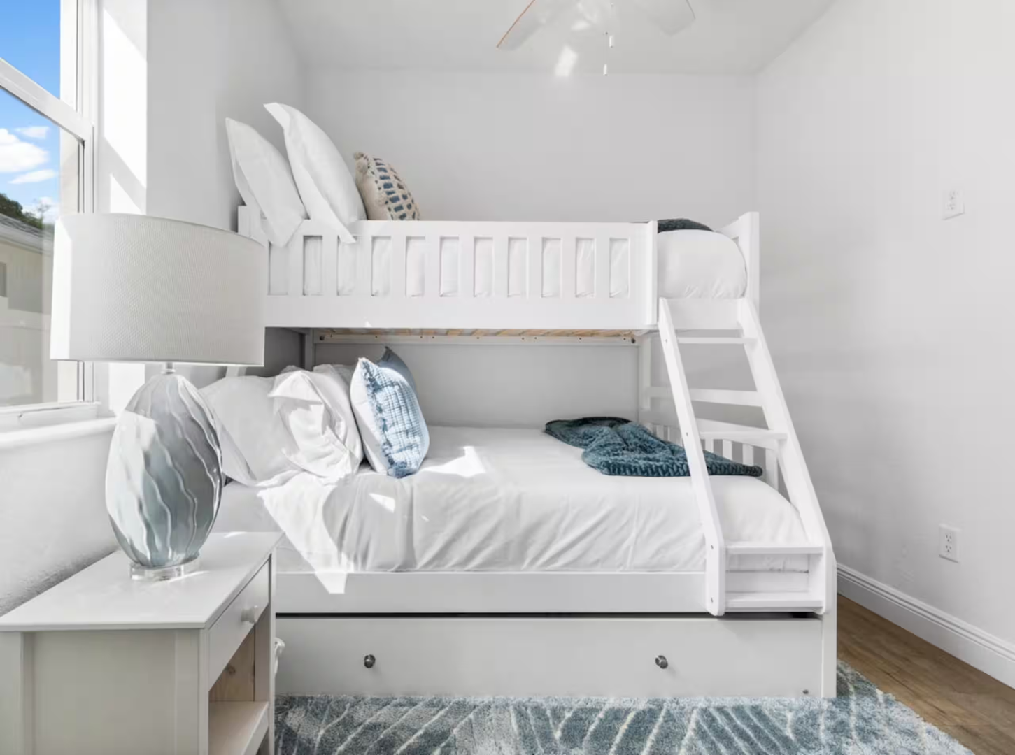Your beachside bunk room awaits with crisp white linens, playful coastal accents, and built-in storage—perfect for sweet dreams after sun-soaked adventures.