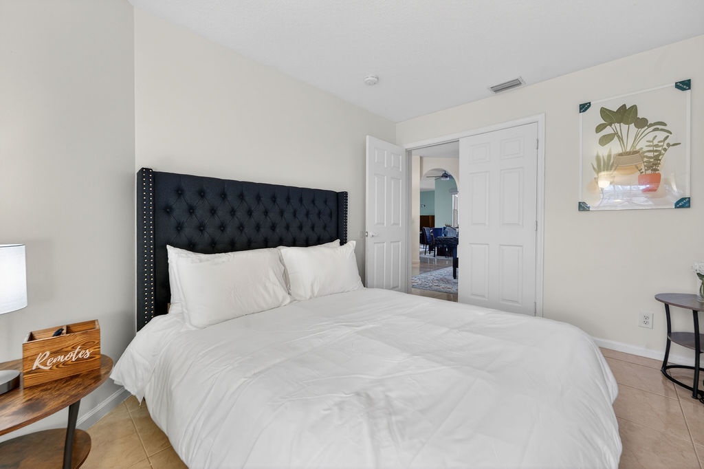 Sink into luxurious comfort with crisp white linens and an elegant tufted headboard that frames your perfect night's rest.