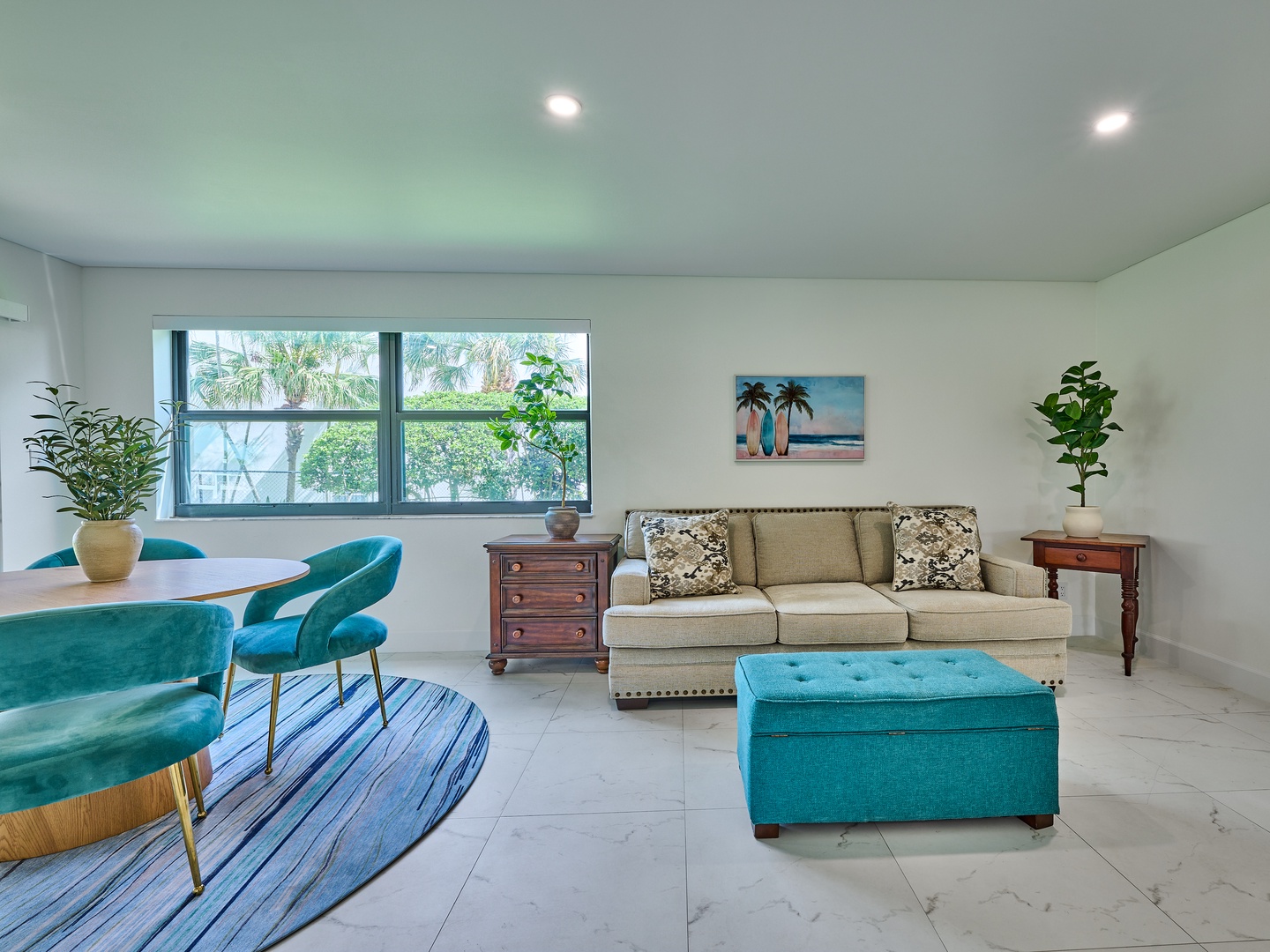 You'll love relaxing in this bright, open living space with stylish seating and vibrant pops of color. Natural light fills the room, and palm trees greet you through the window—a perfect place to unwind after your adventures.
