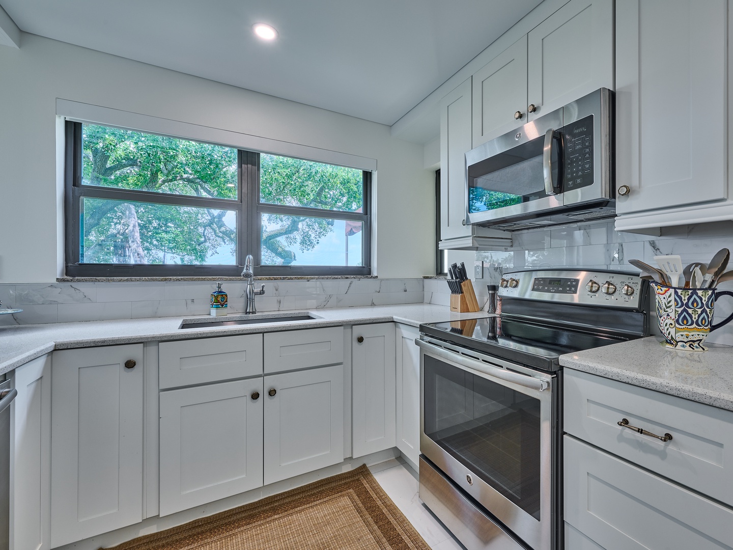 Your bright, fully equipped kitchen with stainless steel appliances and garden views makes meal prep a joy, whether you're starting your day with coffee or cooking a family feast.
