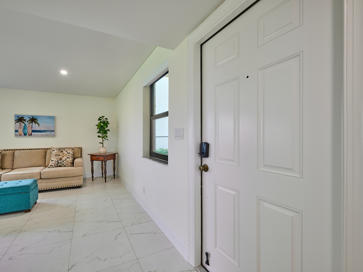 Step into your bright, comfortable living area where soft neutral tones and coastal artwork create an instantly welcoming retreat for your vacation.