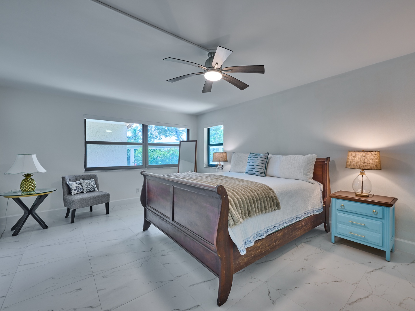 Sink into your plush king bed after a day exploring nearby beaches and local attractions. Soft linens, gentle ceiling fan breezes, and natural light filtering through oversized windows create a peaceful retreat you'll love coming home to.
