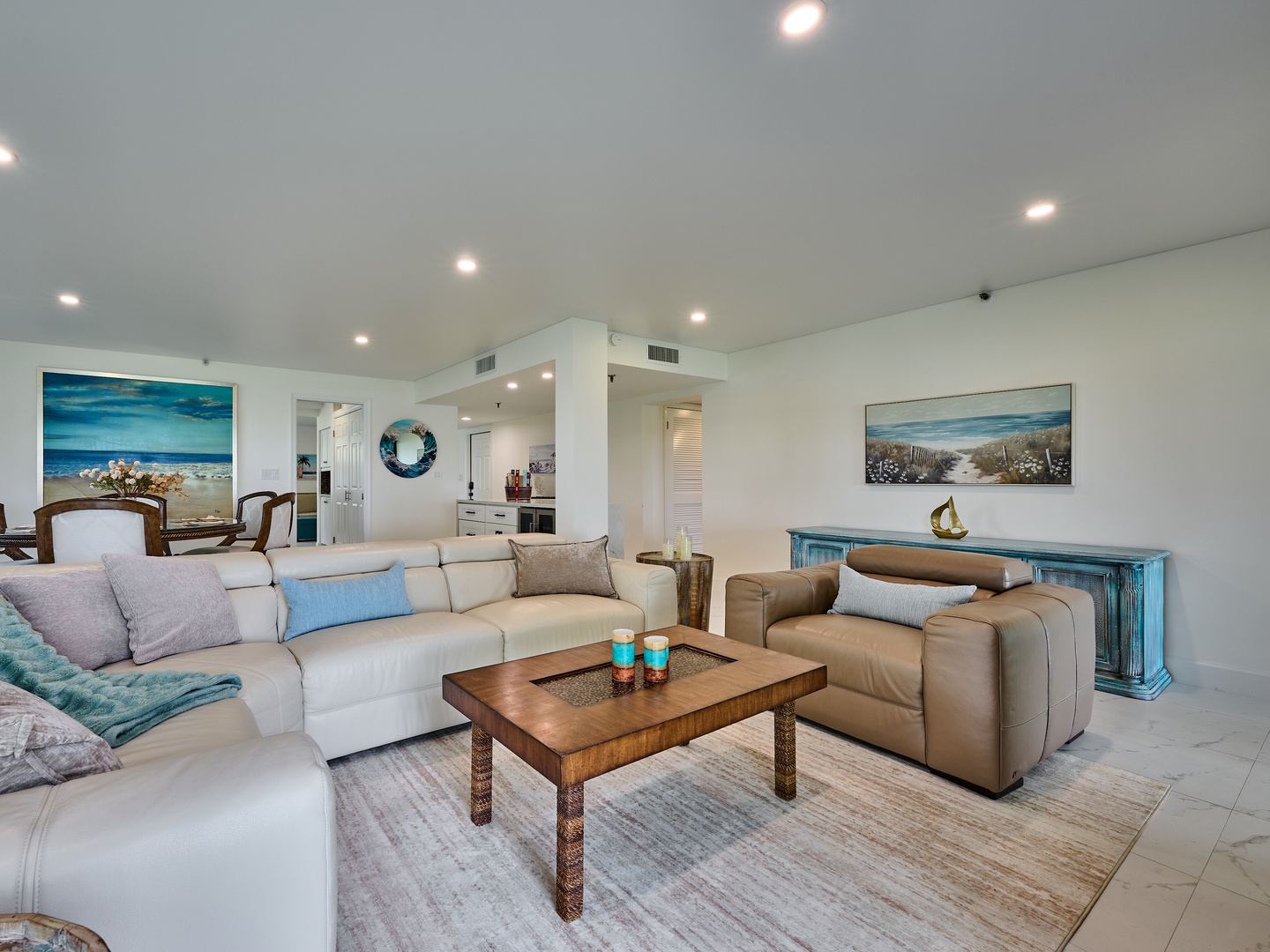 Settle into coastal comfort in this bright, open living space with plush seating and soft blue accents that echo the beach. Relax with your favorite people in a room designed for laid-back conversation and peaceful evenings.