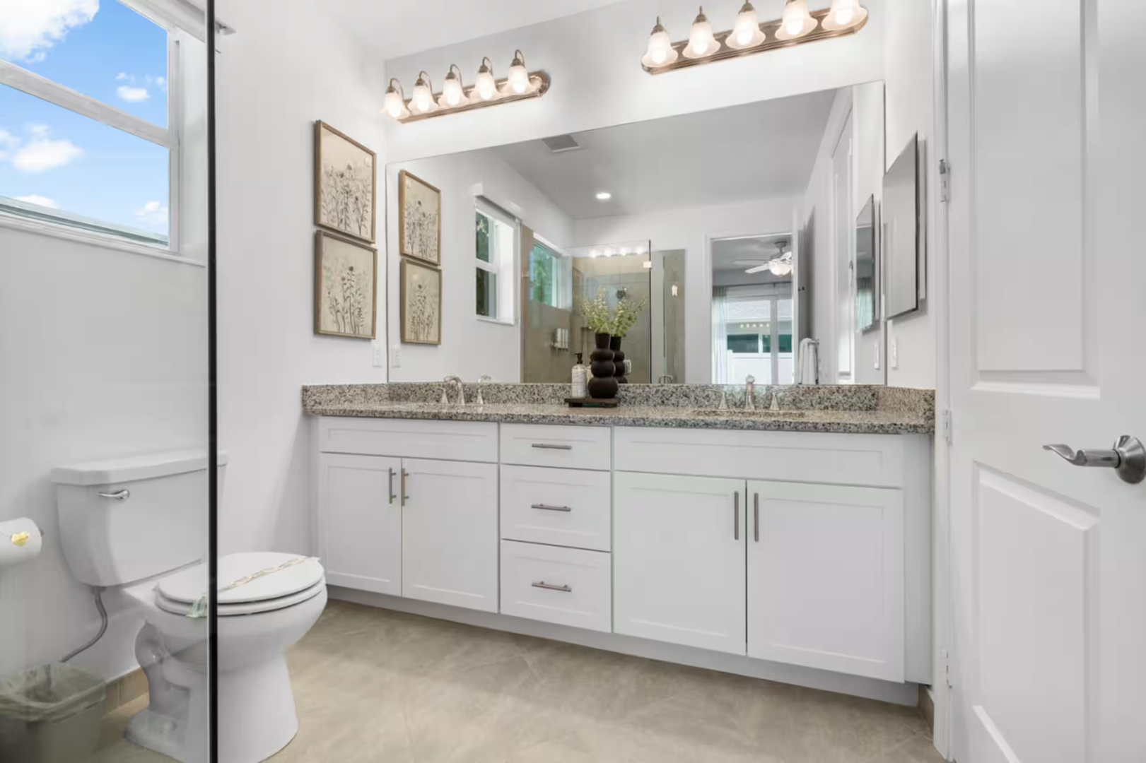 Bright, airy bathroom with dual vanities, polished granite counters, and modern fixtures—your private retreat to refresh and recharge.