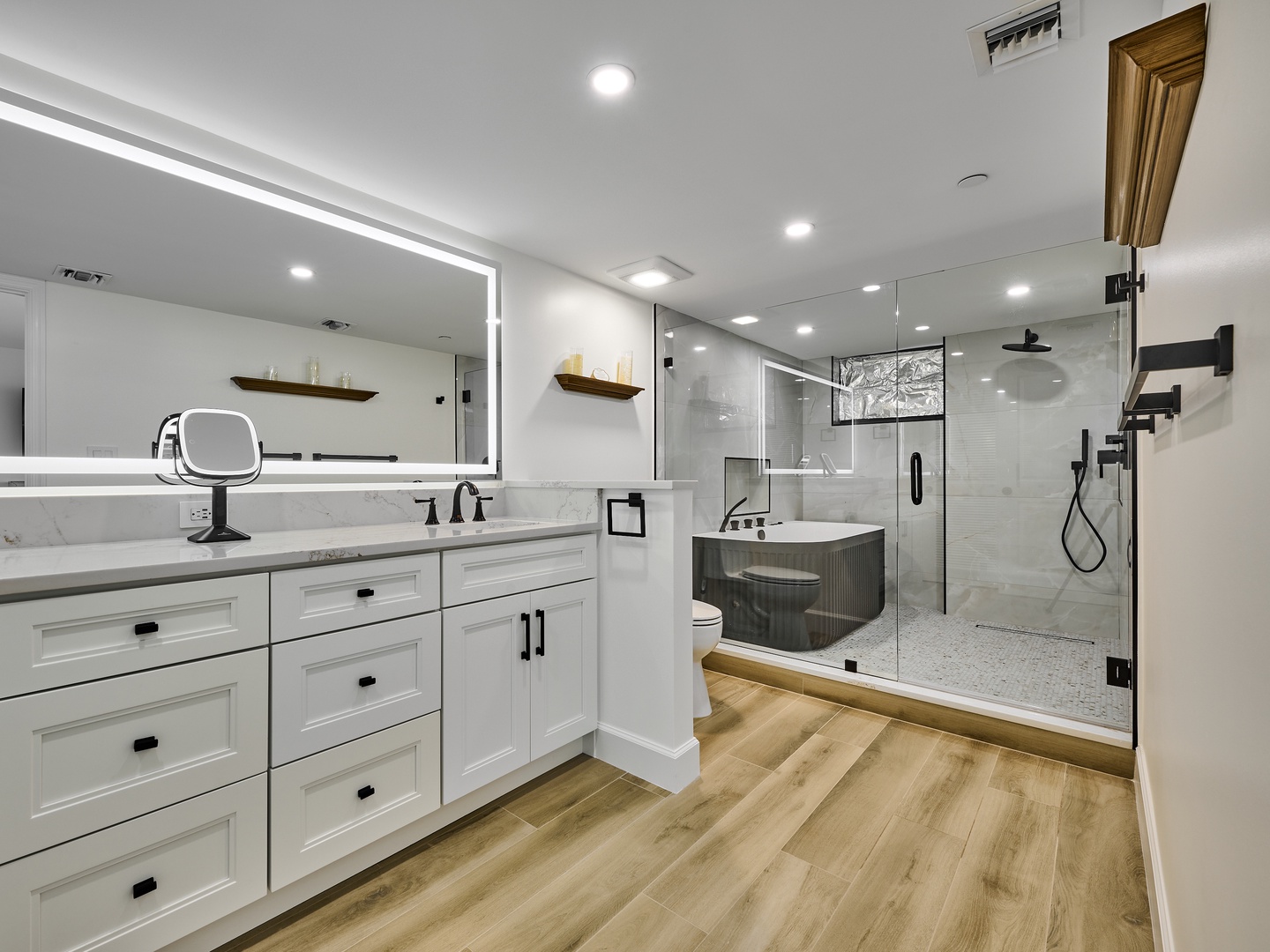 Your spa-like retreat awaits with a sleek double vanity, spacious walk-in shower, and elegant soaking tub—all bathed in soft lighting that makes every moment feel luxurious.