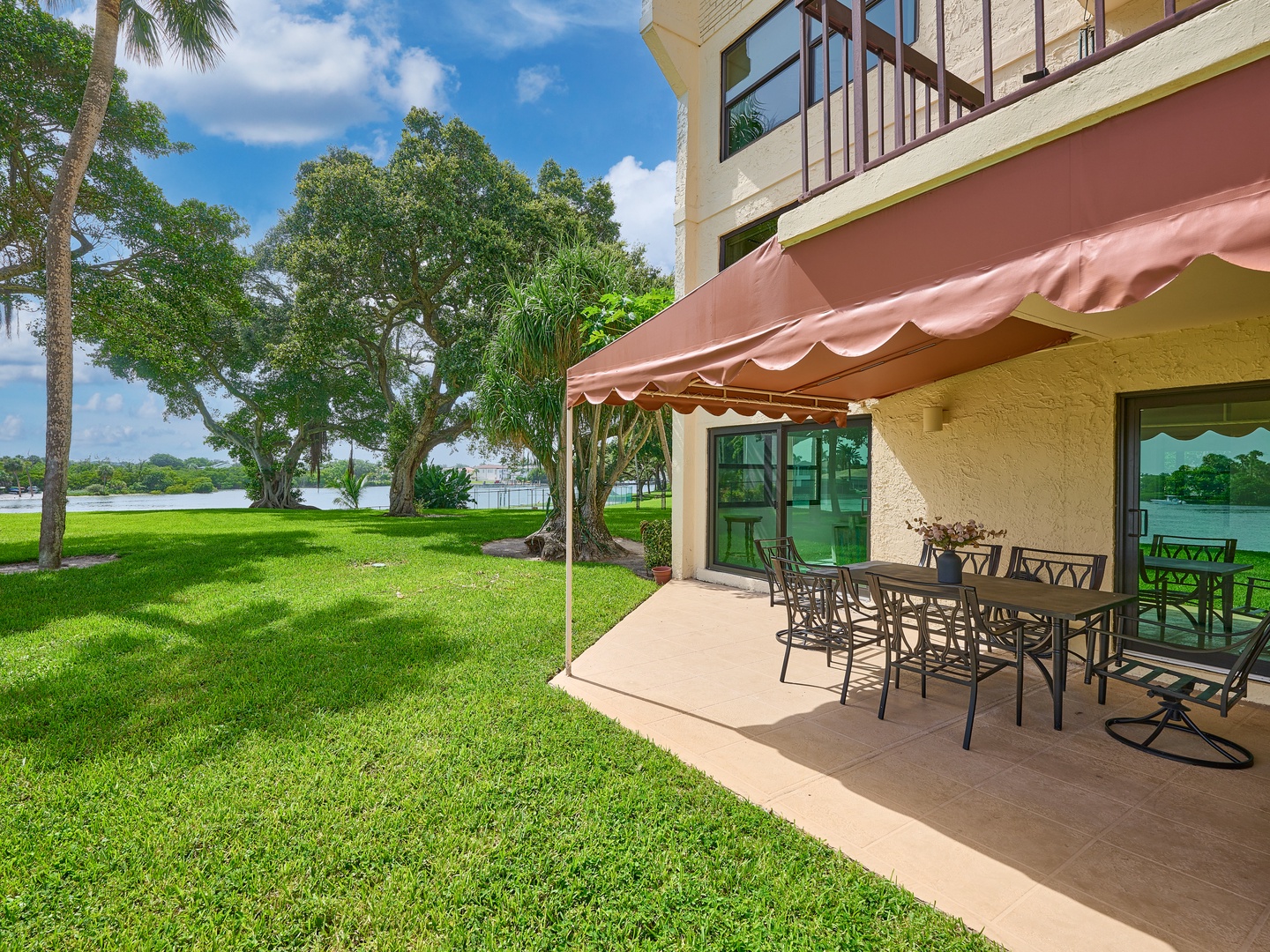 Step outside to your private patio overlooking tranquil lake views, where lush green lawn meets sparkling water. Perfect for morning coffee or alfresco dining under the shade.