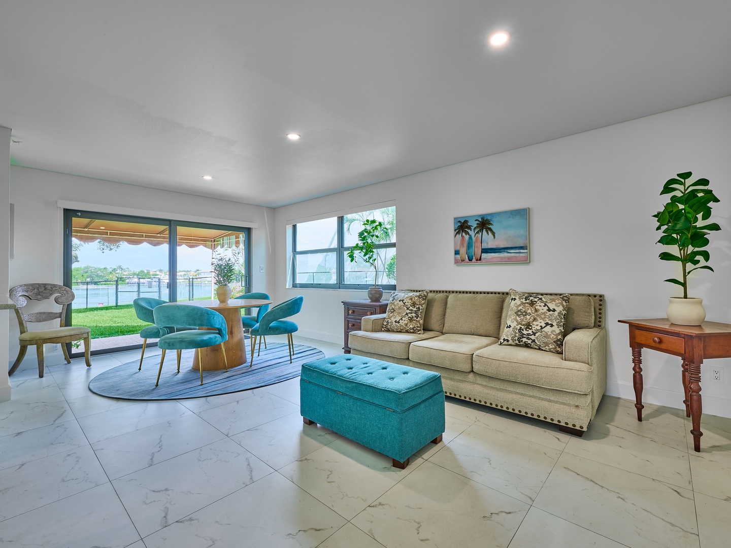 Step into your bright, inviting living space where coastal vibes meet modern comfort. Through the glass doors, you'll find your own private outdoor area—a perfect spot to unwind with morning coffee or evening conversations.