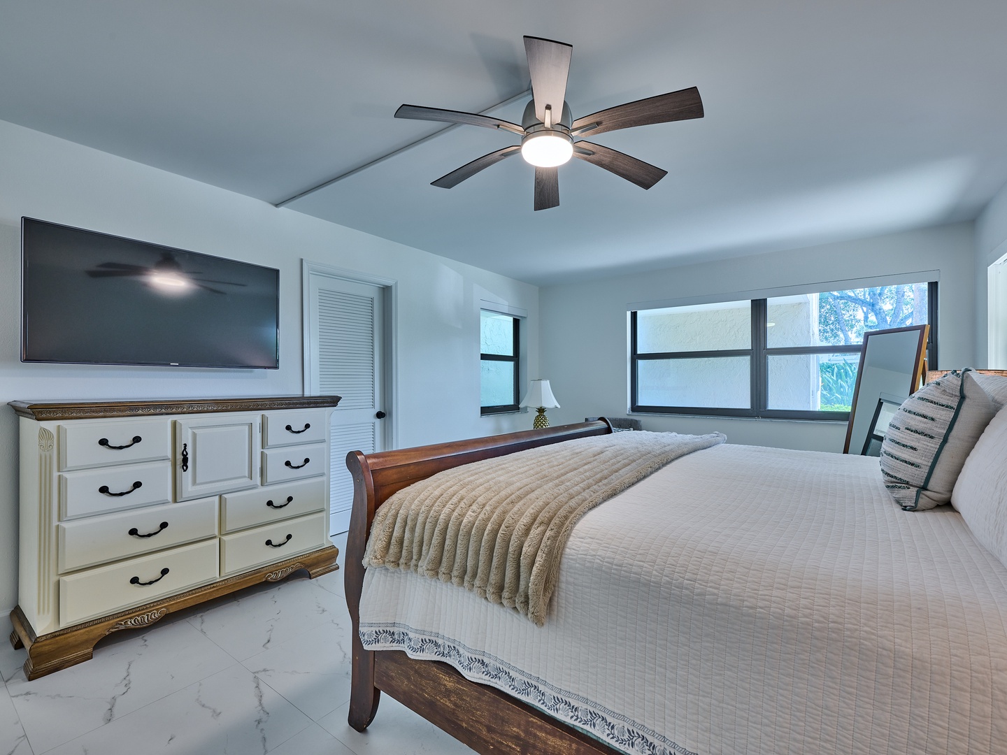 Your peaceful primary bedroom offers restful nights beneath a stylish ceiling fan, with plenty of natural light and thoughtful touches to help you feel at home.