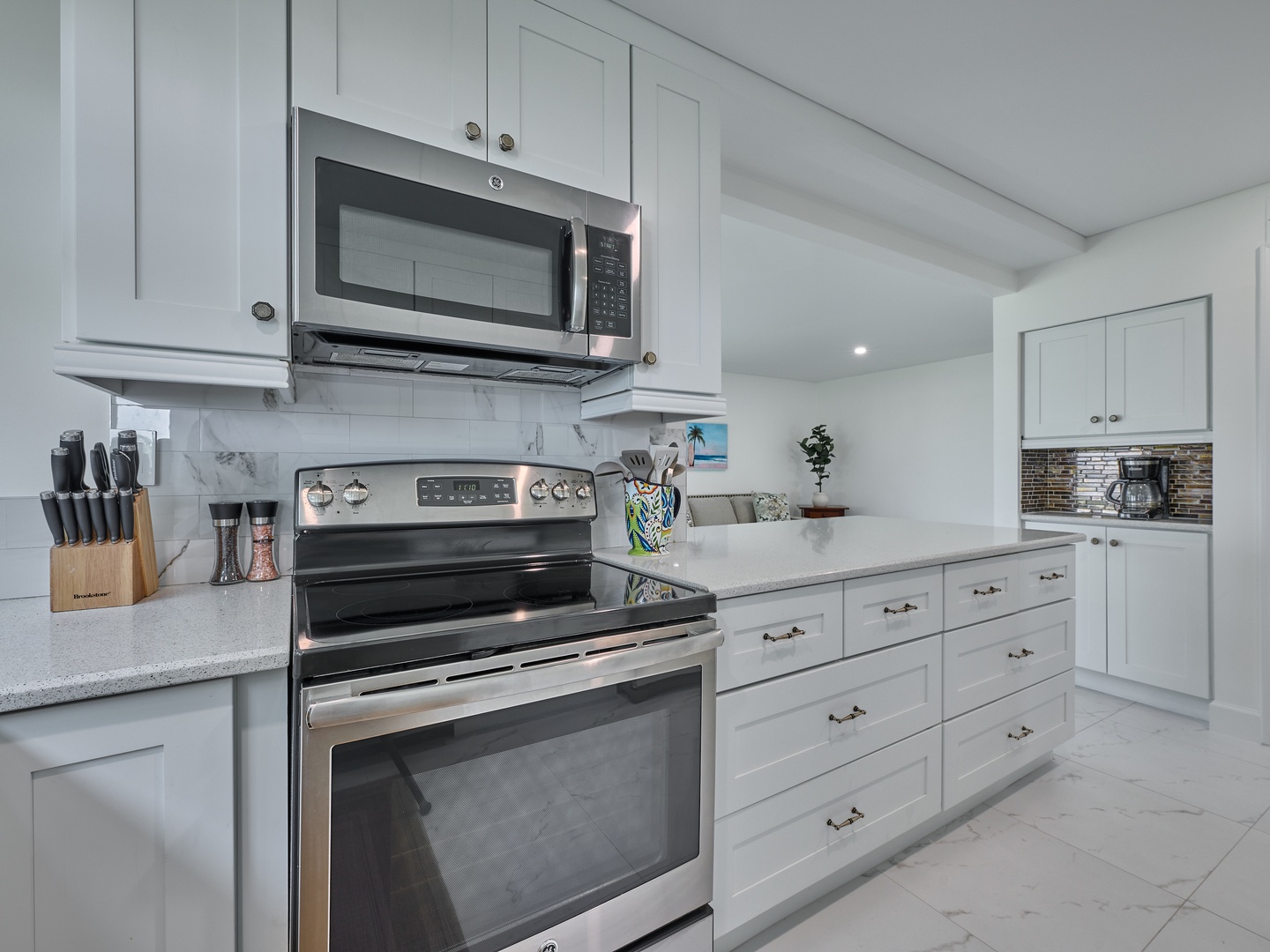 Your spacious kitchen awaits with sleek white cabinetry, stainless steel appliances, and quartz countertops. Everything you need to whip up meals or enjoy morning coffee in style.