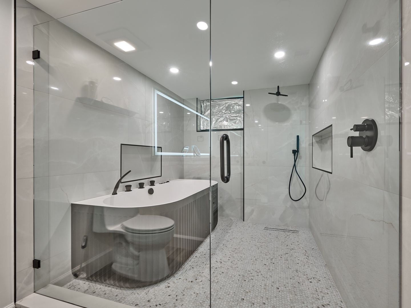 Step into your private spa-like retreat with a spacious walk-in shower featuring sleek marble tiles, elegant black fixtures, and a rainfall showerhead that invites complete relaxation.