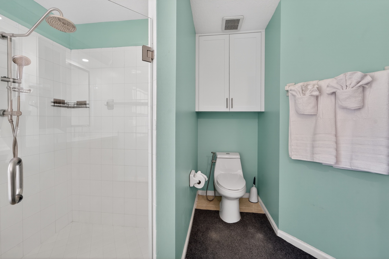 Refresh in your private spa-like bathroom with soothing mint walls, rainfall shower, and plush towels waiting for your arrival.