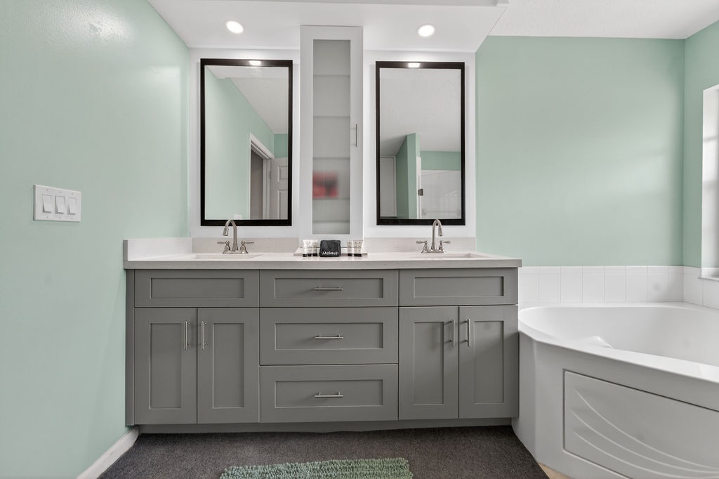 Unwind in your elegant ensuite with dual vanities, soaking tub, and calming mint walls.
