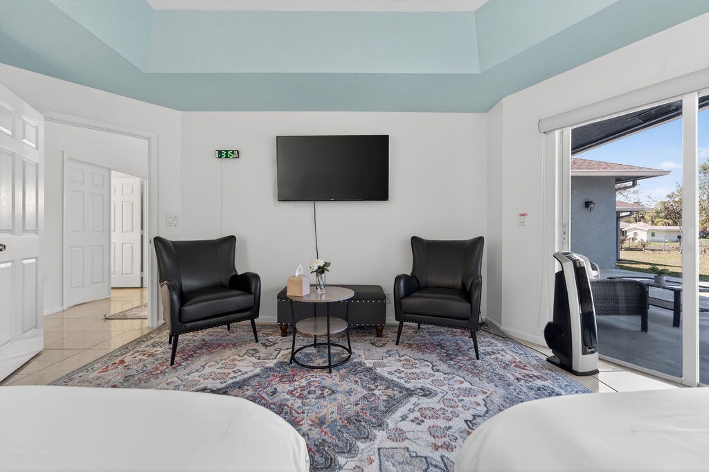 Unwind in your elegant seating area with leather chairs and smart TV, perfect for cozy evenings.