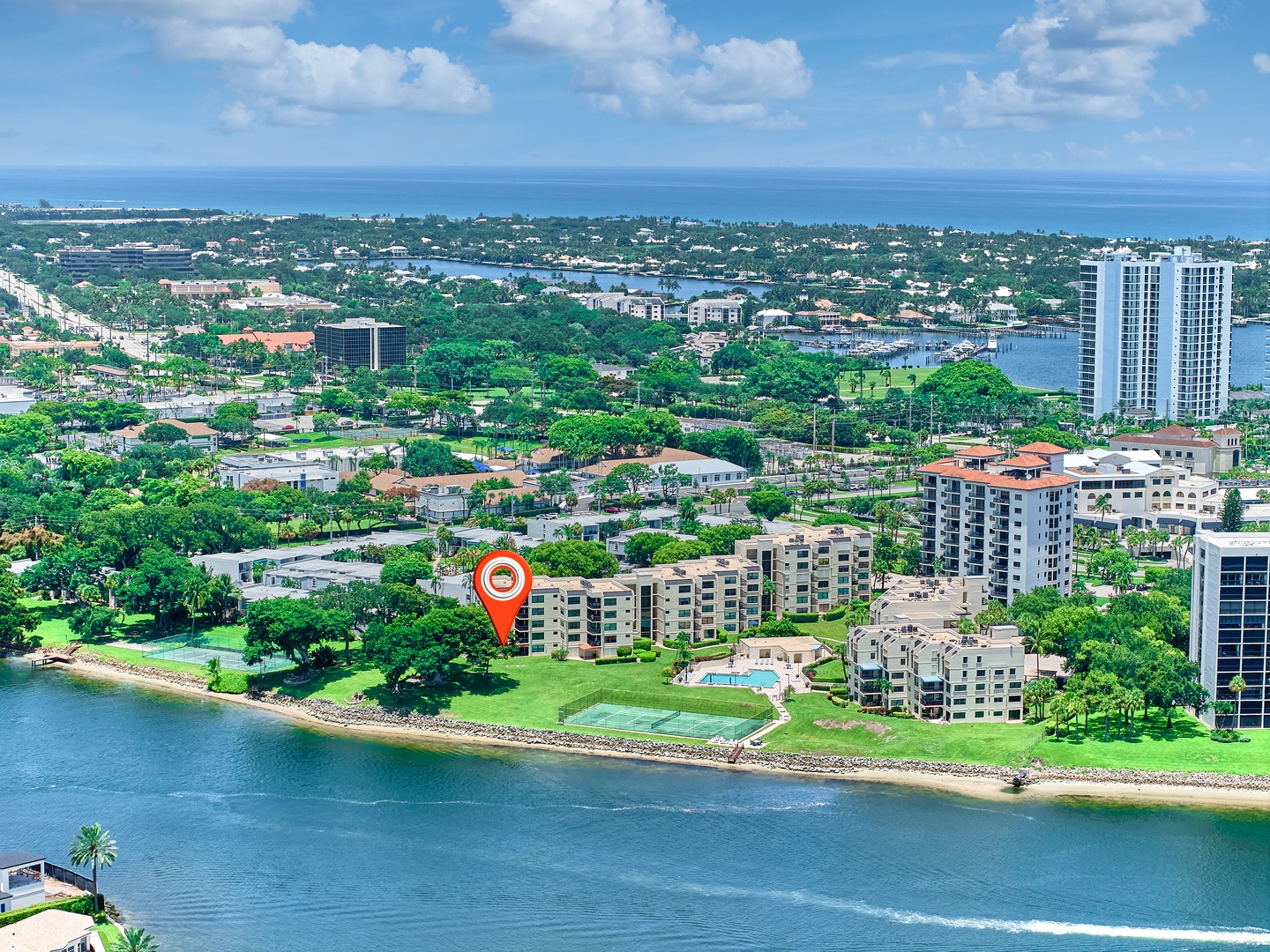 This waterfront property sits in a lush coastal neighborhood with ocean views, green spaces, and water access—a peaceful retreat surrounded by tropical scenery.