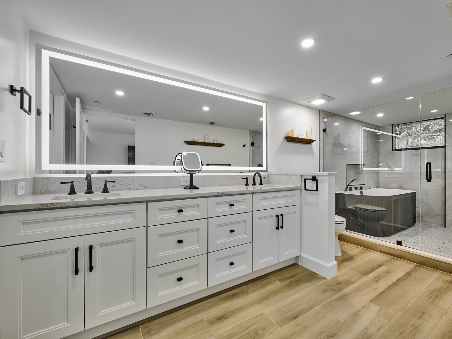 Unwind in your luxurious spa-inspired bathroom featuring dual vanities, a soaking tub, and a walk-in shower—your private retreat for relaxation.