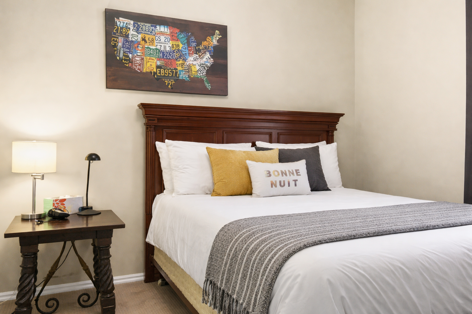 Sink into crisp white linens and colorful pillows in your beautifully appointed bedroom, complete with thoughtful bedside lighting for late-night reading.