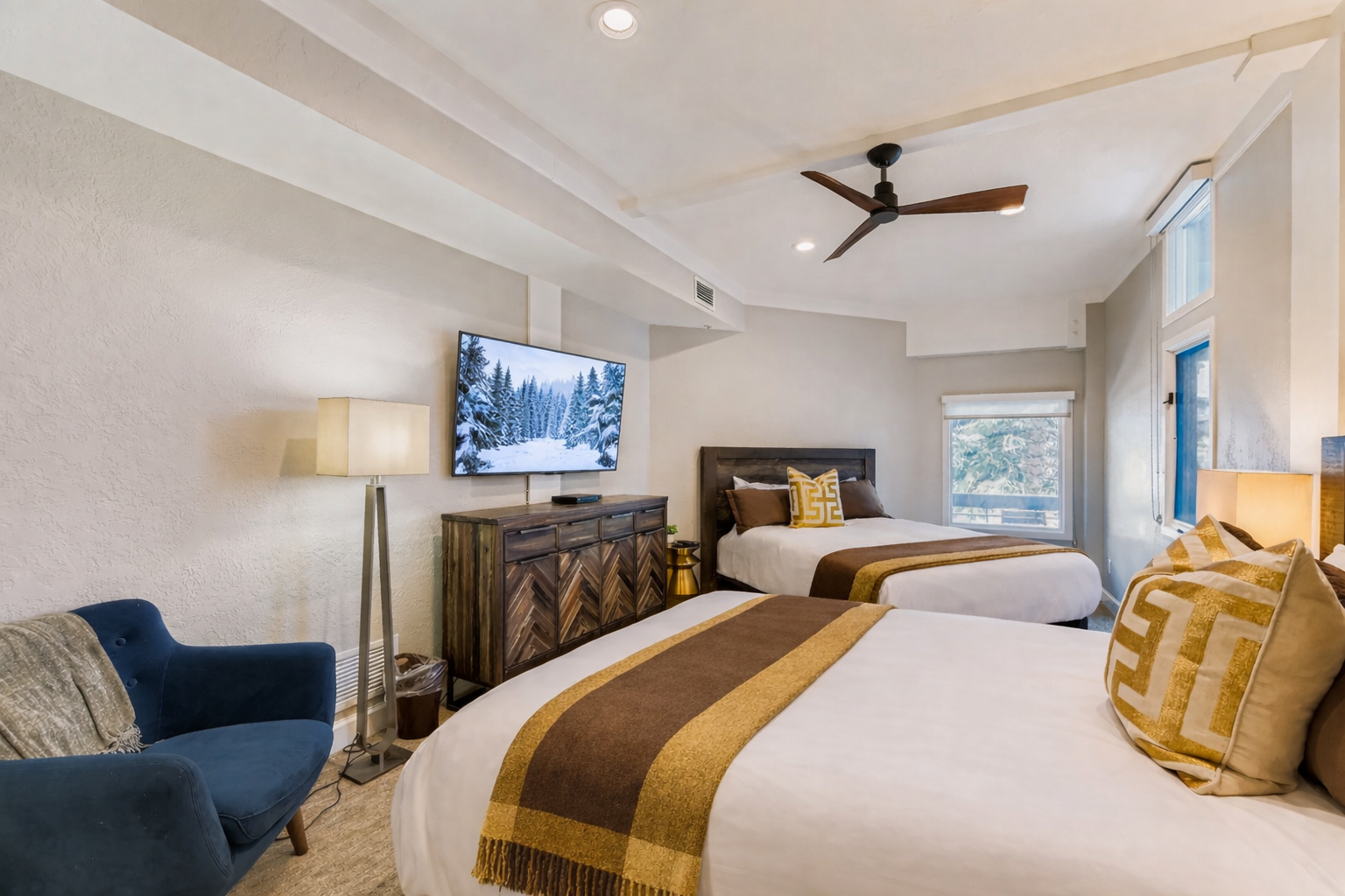 Relax in your comfortable twin bedroom featuring premium linens, modern furnishings, and entertainment amenities for a perfect night's rest.