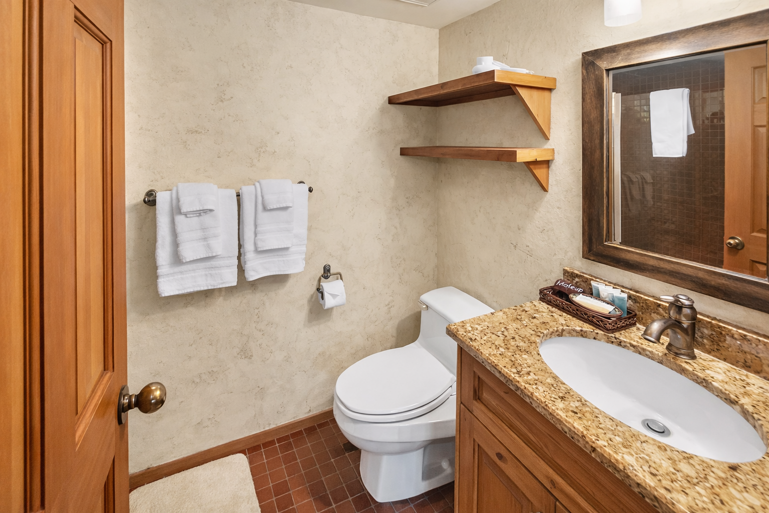 Refresh in our well-appointed bathroom with granite countertops, rustic wood accents, and a full set of amenities. Stocked for your comfort.