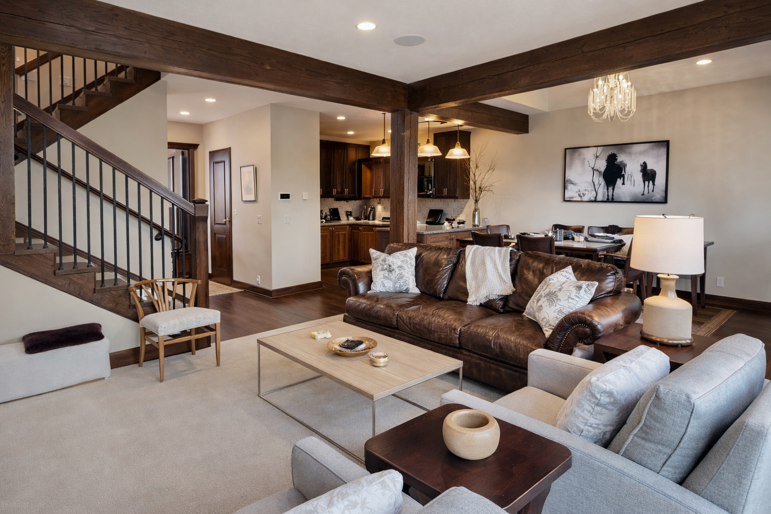 Sink into plush leather sofas in your spacious living area, where rustic beams and modern comfort create the perfect retreat for relaxation.