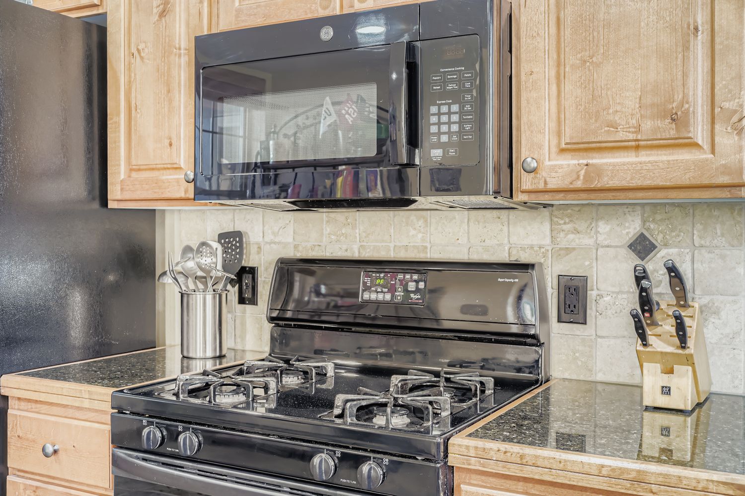 Your fully equipped kitchen features modern appliances including a gas range, microwave, and granite countertops for all your culinary needs.